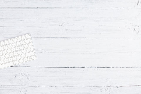 silver computer keyboard on white wooden table